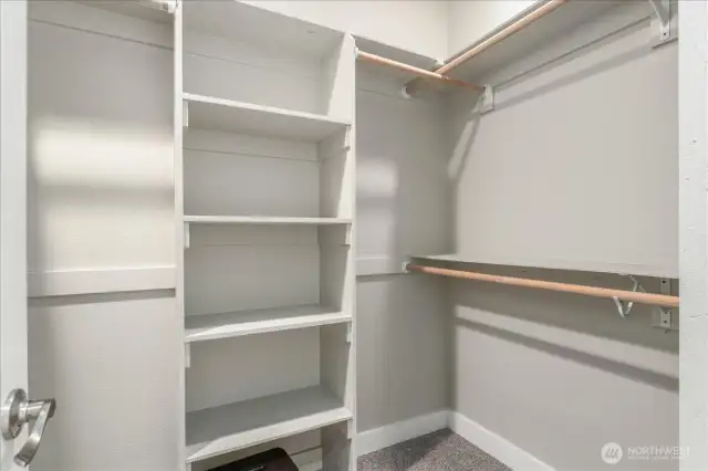Primary bedroom walk in closet