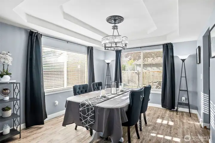 Formal dining area with beautiful chandelier. Large windows bring in lots of natural lighting to the space.