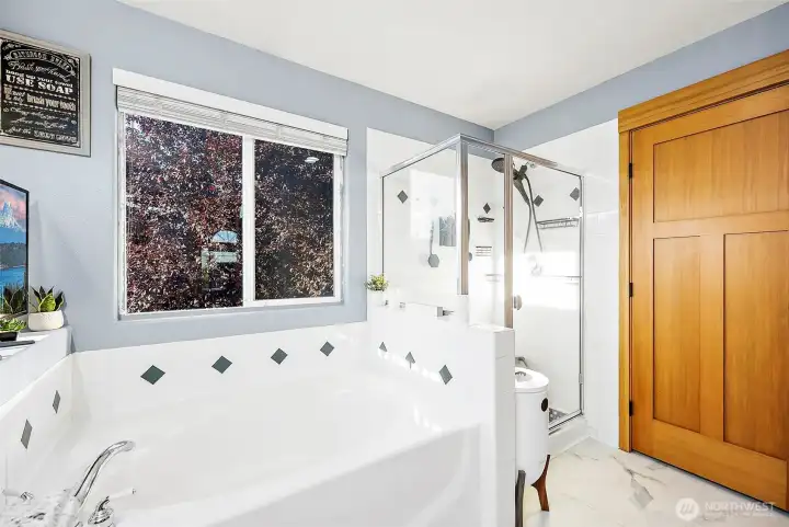 Primary en-suite bathroom looking toward walk-in closet