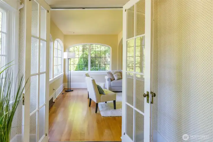 Glass French doors separate the space while still allowing enjoyment of the light and feel of home.