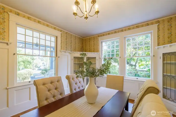 Gorgeous trim and original built-in corner hutches with leaded glass doors here.