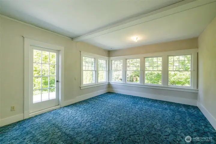 This room above the living room offers the same sunny aspect as the sun room with its wall of windows and has a walk in closet as well.