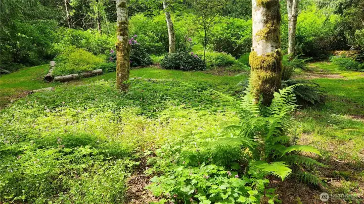 Thoughtfully parked out grounds and flower gardens throughout the property