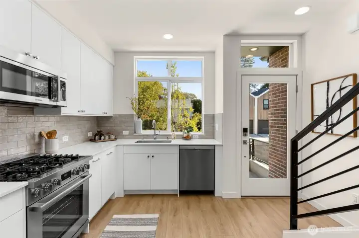 A harmonious blend of form and function defines the kitchen layout, connecting easily to the adjacent living and dining areas.