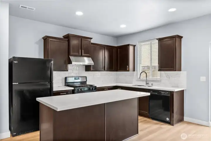 Open kitchen with quarts counters, subway tile backsplash, and new fridge and stove coming today!!  Pictures to follow!  Happy Holidays!!