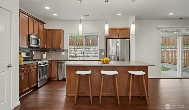 Open gourmet quartz kitchen.
