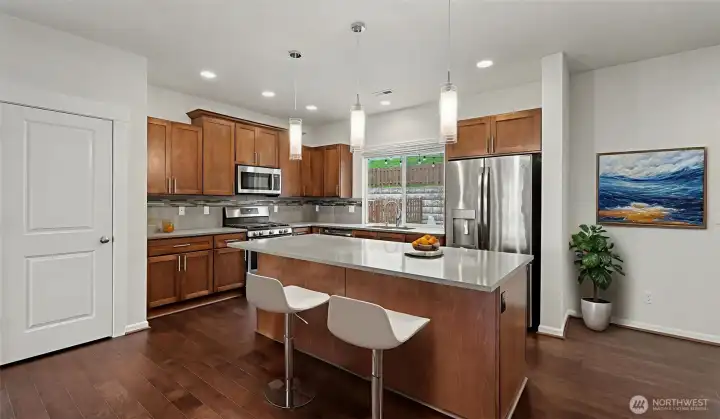 Open gourmet quartz kitchen.