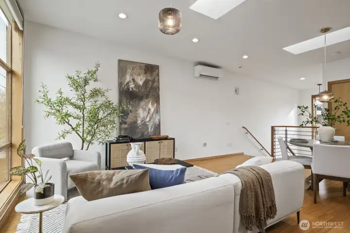 Skylights and floor-to-ceiling windows fill the main living spaces with year-round light.