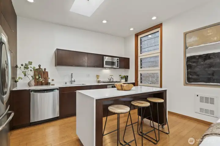 A large island anchors the kitchen and offers room to gather, enjoy leisurely morning coffee, or watch the chef at work.