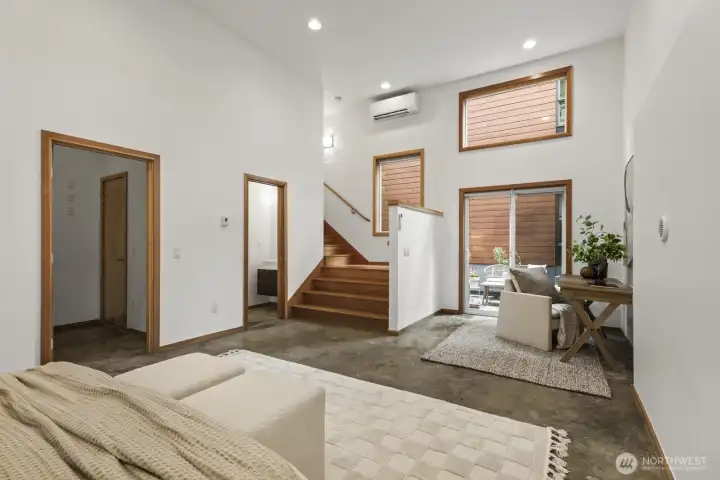 Soaring high ceilings and plentiful windows ensure this space doesn't feel like you're in a basement.