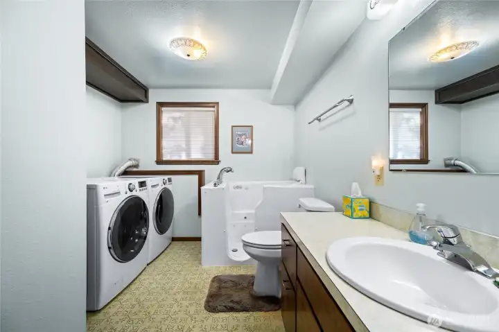 Full bathroom with laundry on lower level. Bathrub is Japanese style sit-in.
