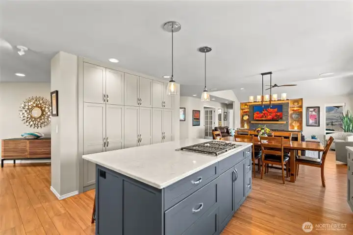 Kitchen includes a large built-in pantry with pull-out shelves, offering optimal storage, organization, and easy accessibility.