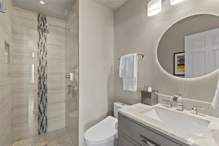 Beautifully remodeled upper level 3/4 bathroom with a stunning tile shower located near the office.