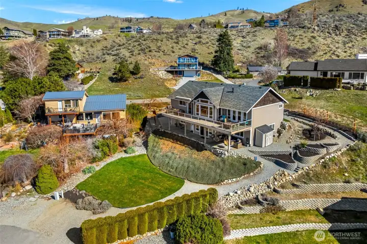 Terraced garden beds paired with a well-placed storage shed create the perfect setup for gardening, and driving access from Stehekin Way as well as from Wapato Court on the lower yard provide lots of flexibility.