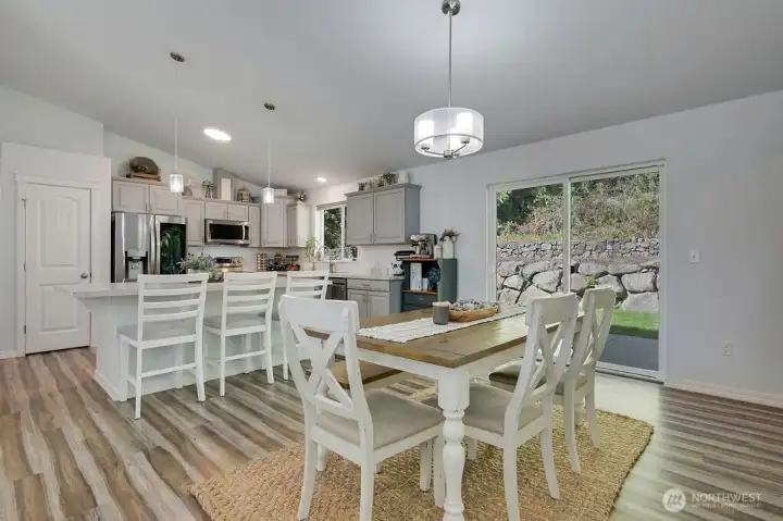 View of the kitchen and dining show how open and airy.  Sliding glass door to backyard.