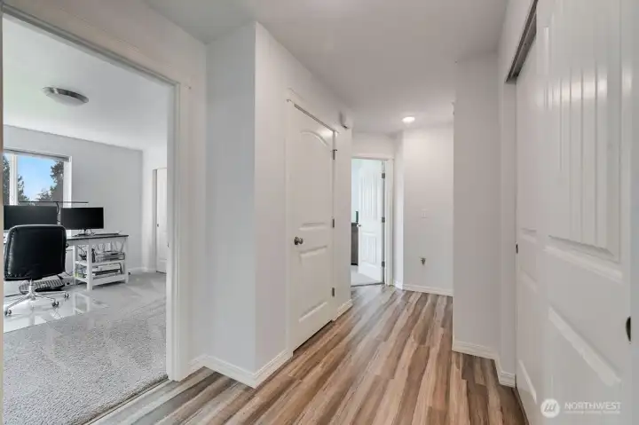 Hallway to the 2 bedrooms and primary bedroom.