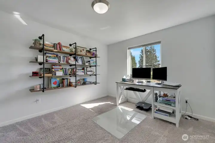 This versatile room with filtered views of water is ideal for home office, guest space, or a studio with natural light.