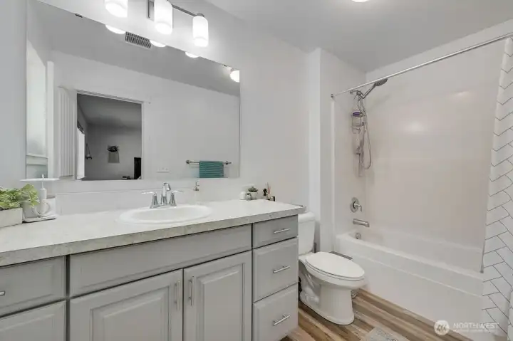 Primary bathroom has plenty of vanity area and a full tub/shower for convenience.