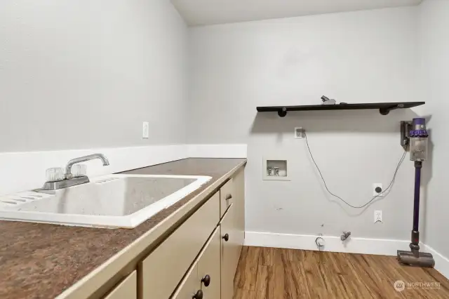 Spacious utility room conveniently located near the primary suite
