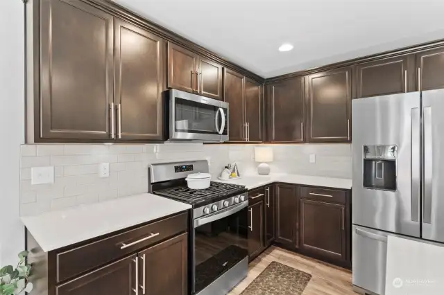 Stainless-Steel appliances including a gas stove/range.