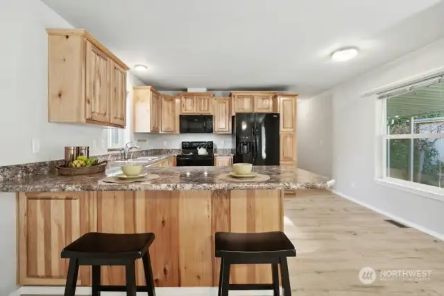 Ample, Pine kitchen Cabinet with breakfast eating area.