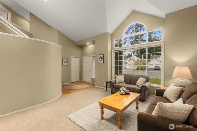 View of Living Room showing Front Door and Closet. Vaulted Ceiling & Double Pane Windows