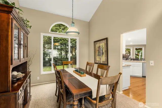 Dining Room with Vaulted Ceiling & View of Backyard