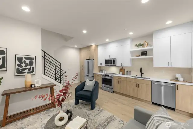 The open-concept living, dining, and kitchen areas create breezy and inviting spaces for entertaining.