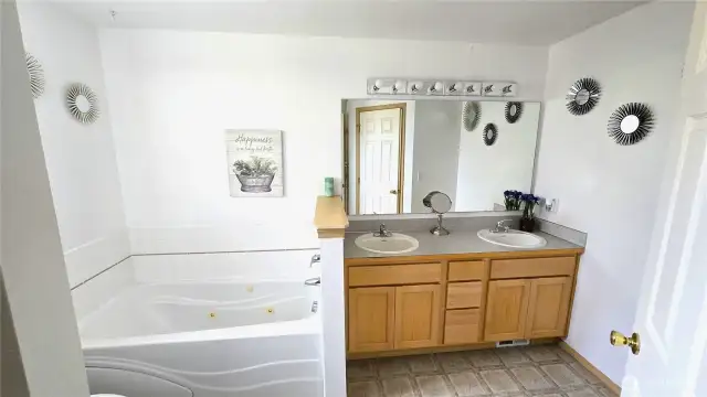 Master Bath with double sink, soaking tub, separate shower and walk in closet