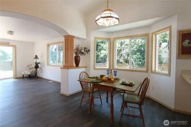 A view of the family room beyond the dining room, towards the walk out deck