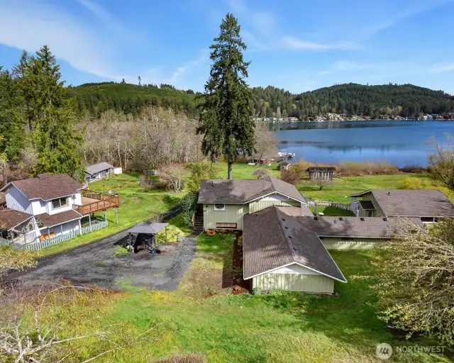 Sitting right on the edge of Summit Lake. The main home is in the center of this photo, with the attached studio apartment on the far right. All of the buildings have addresses on Summit Lake Shore Rd. NW. The main home is 401. The attached studio apartment is 403. The one bedroom home in the left of this photo is 345. There is a cabin not visible in this photo but just beyond the one bedroom home is 347, and the cabin in the distance on the left is 349.