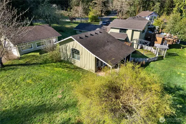 The studio apartment is in the center of this photo. Lake views from the covered porch. To the left is the garage, and the main home is on the right.