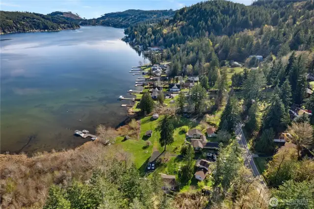 Sitting right on the edge of Summit Lake. The main home is in the center of this photo, with the attached studio apartment on the far right. All of the buildings have addresses on Summit Lake Shore Rd. NW. The main home is 401. The attached studio apartment is 403. The one bedroom home in the left of this photo is 345. There is a cabin not visible in this photo but just beyond the one bedroom home is 347, and the cabin in the distance on the left is 349.