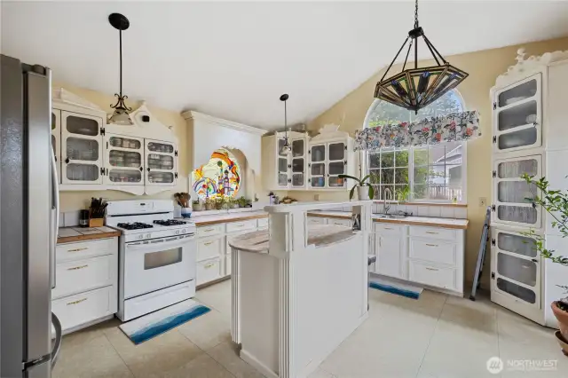 Main home kitchen with propane gas stove & island with granite counters. All five of the units on the property have propane.