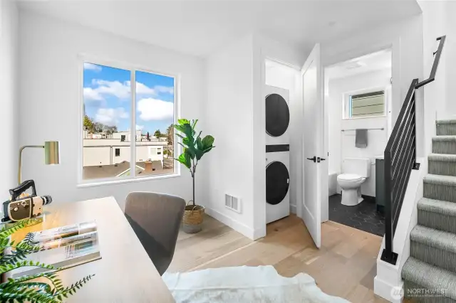 A bright bonus room on the top floor flexes as a WFH office, homework station, or Peloton studio—tucked beside a convenient laundry closet. Photos are of model home 2009B.