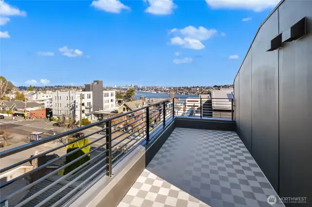 Step onto the rooftop terrace and discover an uninterrupted vista stretching over Lake Union toward Gas Works—Seattle summers start here. Photos are of model home 2009B.