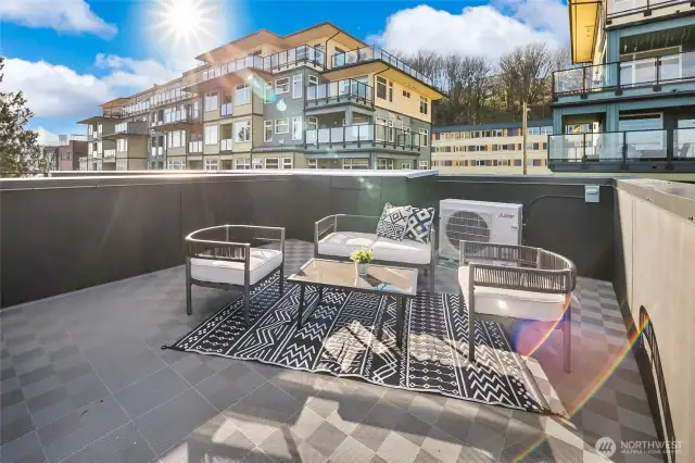 Daytime on the deck brings warm southern exposure—ideal for container herbs or a weekend brunch table shaded by skyline views. Photos are of model home 2009B.