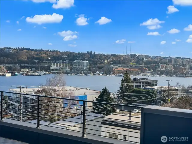 Lean on the railing and trace rowers cutting across the water while seaplanes rise toward the Olympic Mountains. Photos are of model home 2009B.