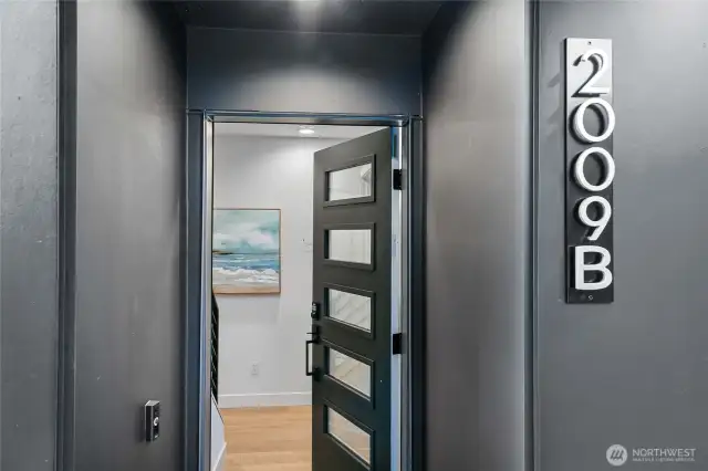 Your private front door, labeled 2009 B, opens directly into the home—no shared corridors, just secure, individual entry. Photos are of model home 2009B.