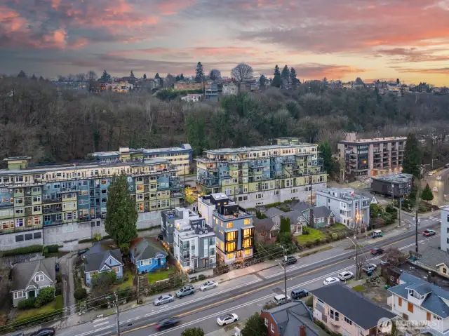 Pull back for a neighborhood panorama—Four Square on Dexter stands out along Dexter Ave, yet nestles comfortably among craftsman homes and greenbelt views. Photos are of model home 2009B.