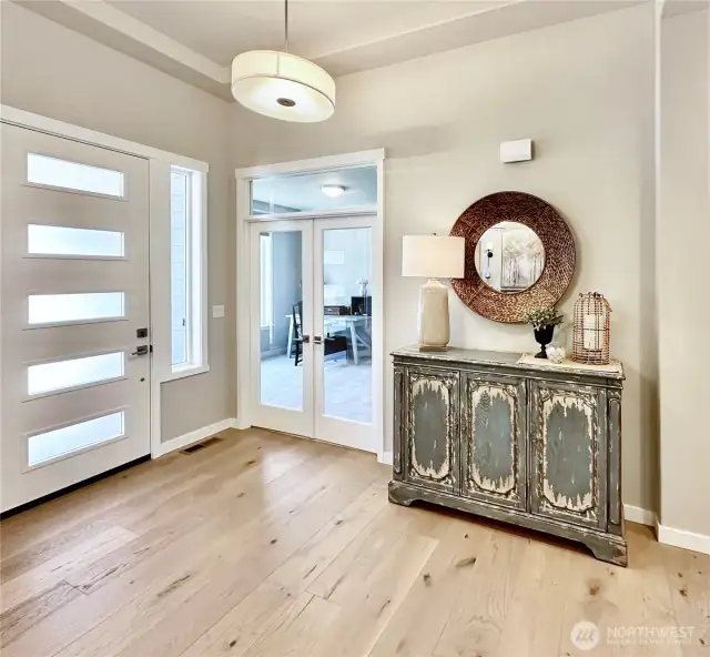 Generous entry with stunning hardwood floors, French doors lead to ample office.