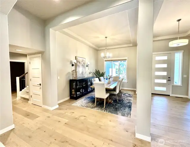 Looking towards dining from kitchen and entry. Stairs to bonus room to the left.