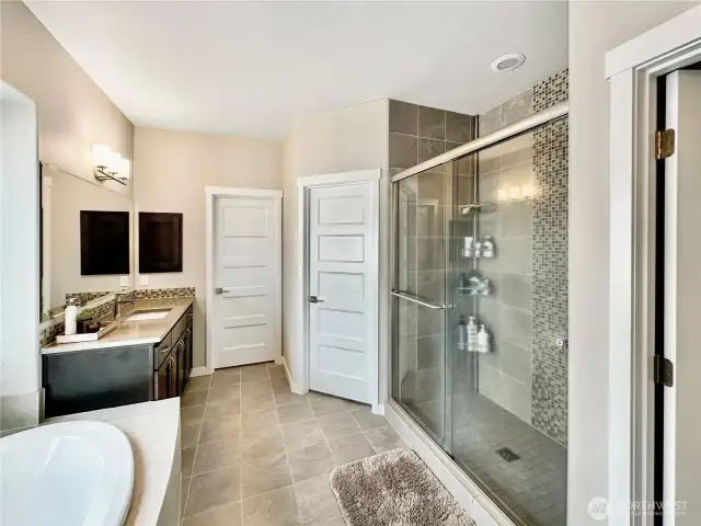 View of large walk-in shower, toilet room just to the right.