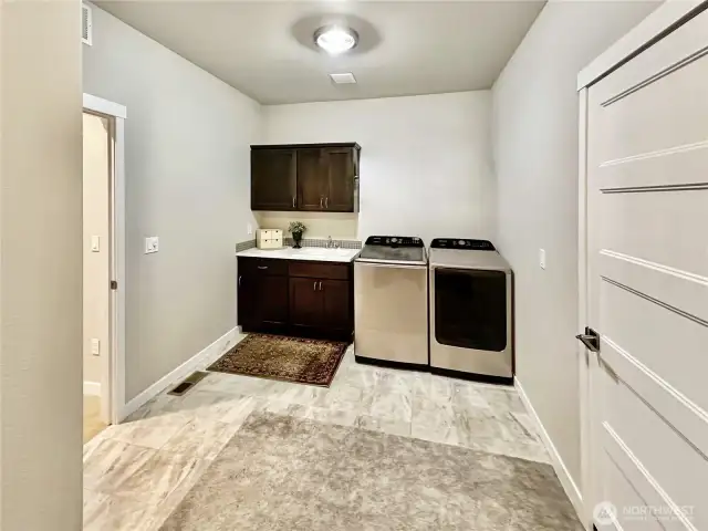 Huge laundry room and additional storage area.