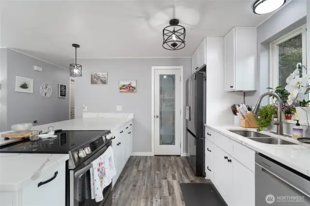 Another view of kitchen, pantry door straight ahead.
