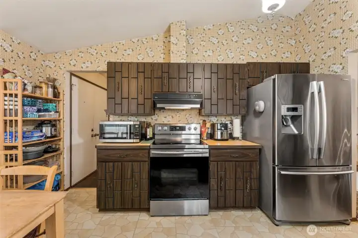Newer stainless appliances included. The original cabinetry is in great shape. The wallpaper and decor brings back memories of a decade of self-realization, personal growth, and well-being. How about you? Will you keep it or change it?