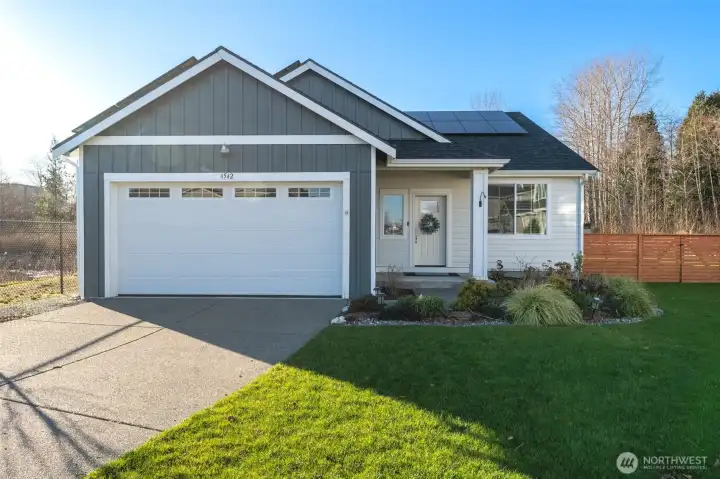 Better-than-new single-level home with modern farmhouse styling, solar panels, and a welcoming covered entry.