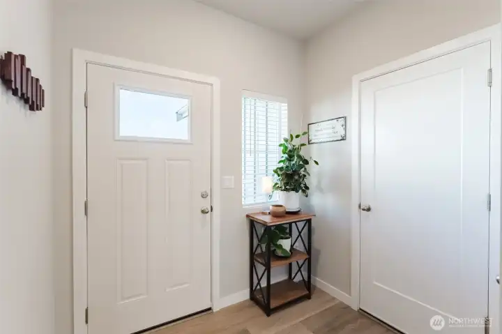 Welcoming entry with natural light, clean lines, door into the garage and convenient closet storage nearby (not pictured).