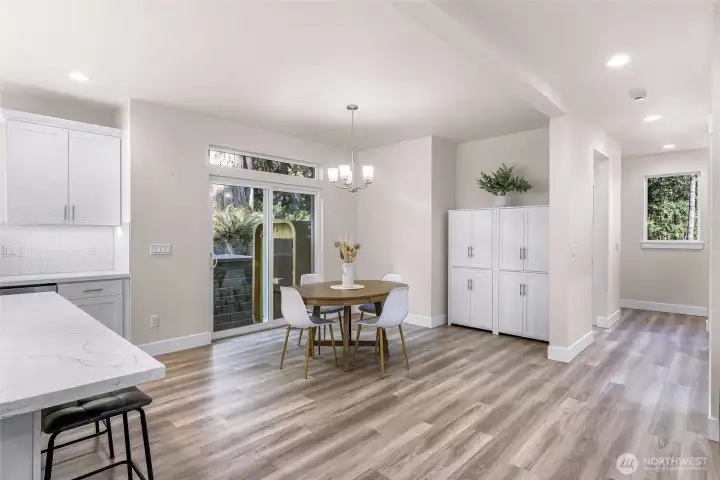 Dining area with space for table and additional storage cabinetry nearby.