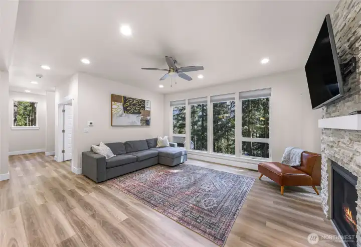 Living space with fireplace, media wall, and flexible furniture layout options.